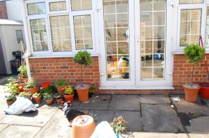 Two bay topiaries frame the conservatory door now