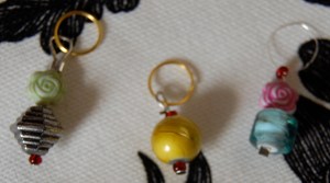 Three little stitch markers sittin' in a row