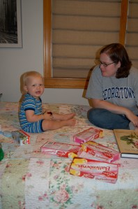 My friend and her little guy with the spoils of travel around them